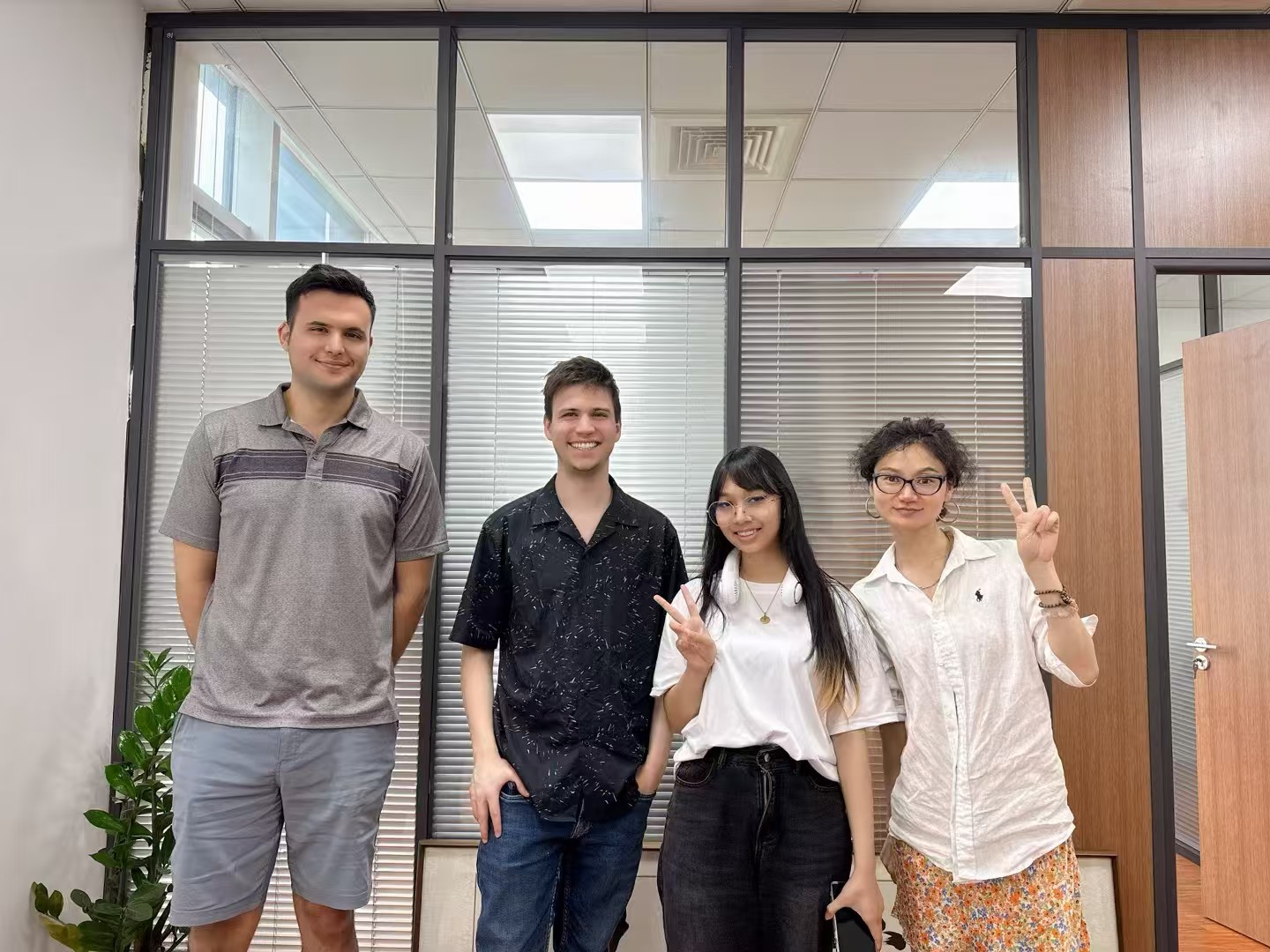 Two male and two female students smiling and looking at the camera